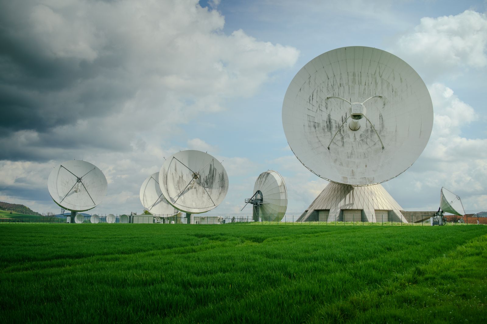 Satellite communications array operating beneath a cloudy sky