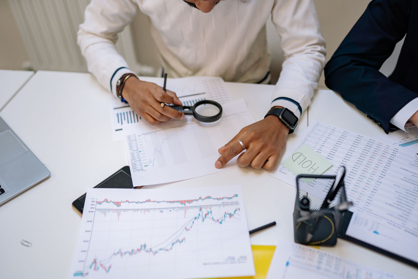 Financial professionals reviewing charts and supporting documents