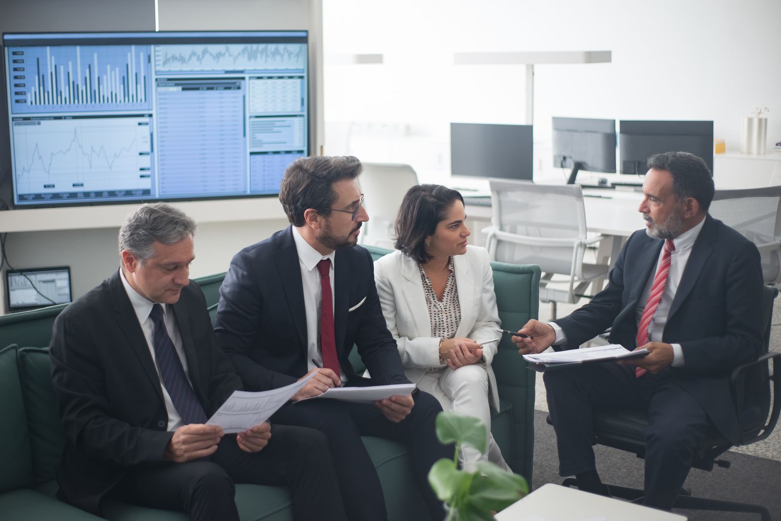 Financial services professionals discussing strategy in a modern office