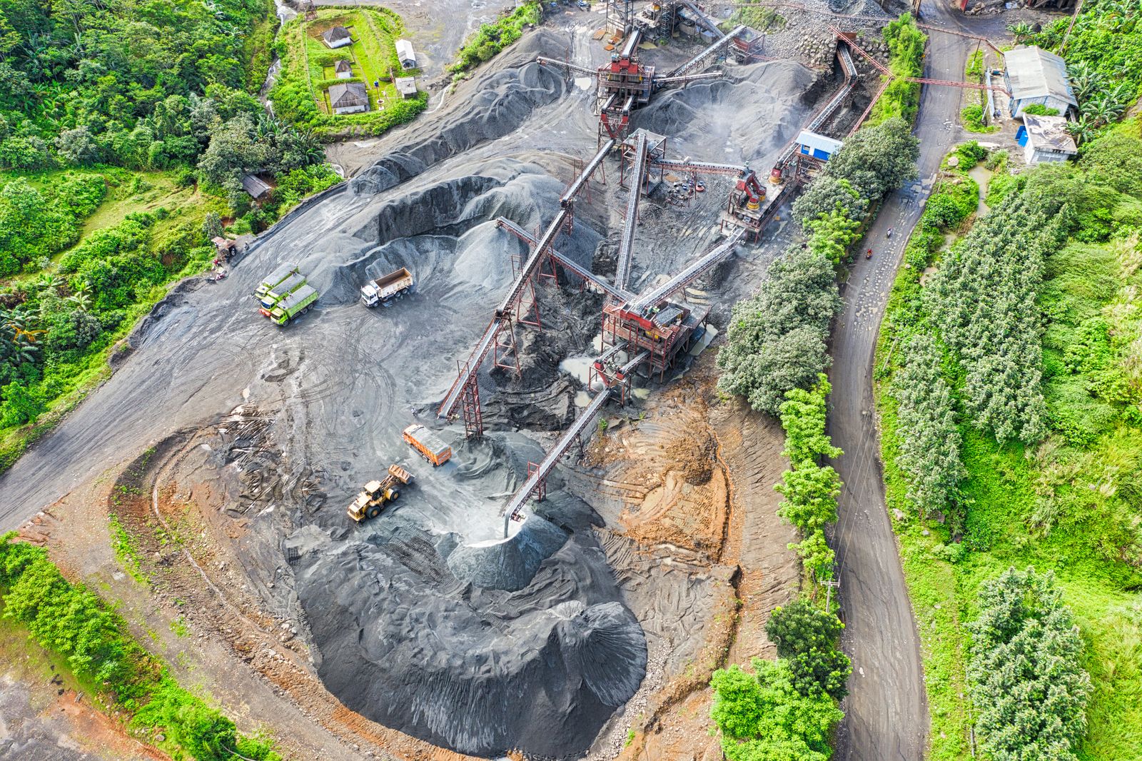 Aerial view of an active mining operation surrounded by vegetation